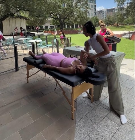 Holly O'Neal guiding an outdoor arm stretch