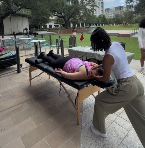 Holly O'Neal giving an outdoor neck massage
